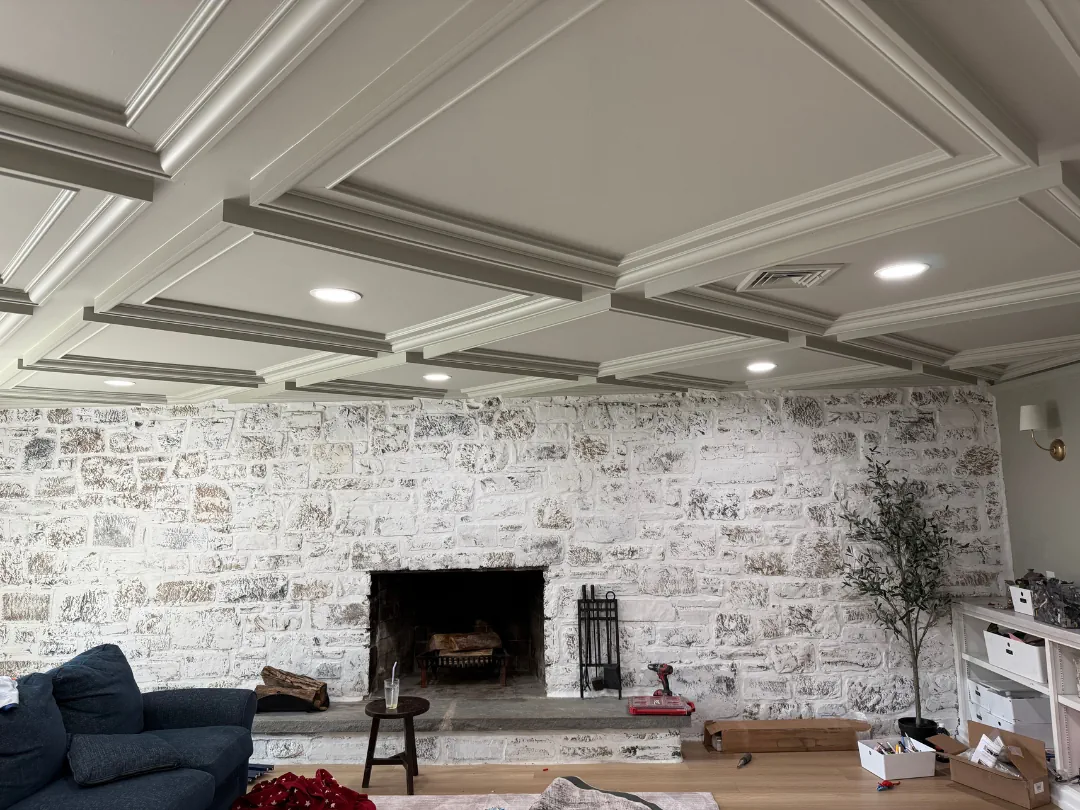 Coffered ceiling and lime-washed stone fireplace wall — interior painting and specialty finishes by SIB PRO PAINTERS, Warminster, PA