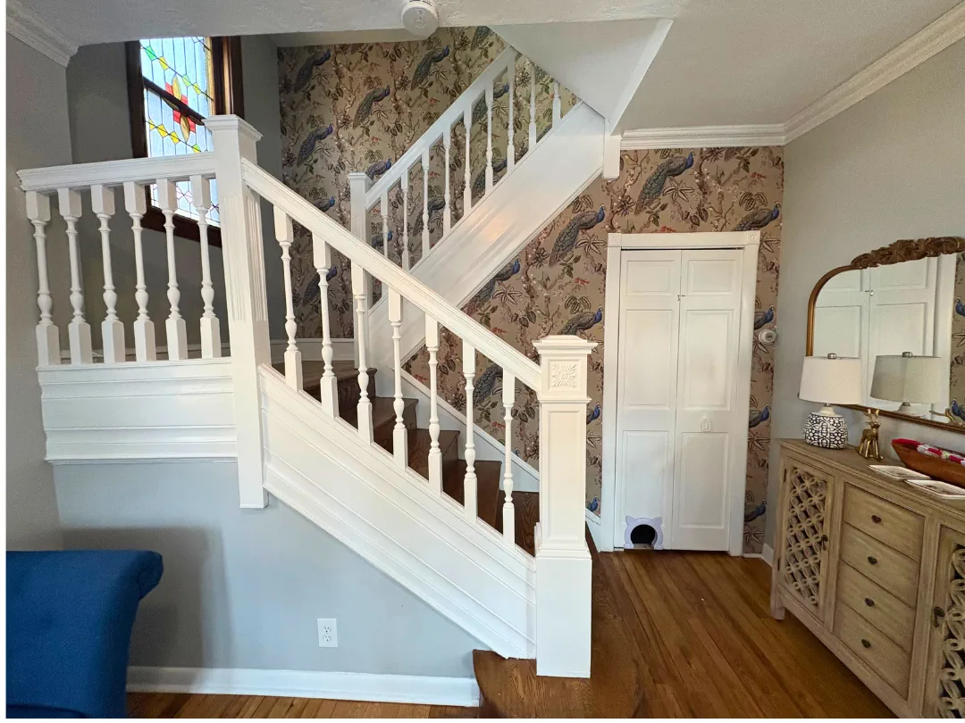 Freshly painted white staircase railing with wallpaper installation — interior painting by SIB PRO PAINTERS, Bucks County, PA